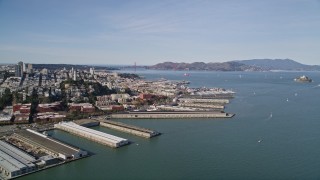 AXSF15_010 - 5K aerial stock footage flyby Coit Tower and North Beach piers, view of Golden Gate Bridge, San Francisco, California