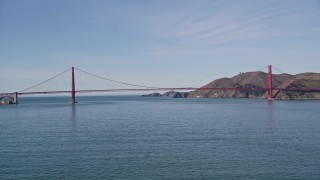 AXSF15_017 - 5K aerial stock footage of approaching boat on the bay, tilt to reveal Golden Gate Bridge, San Francisco, California