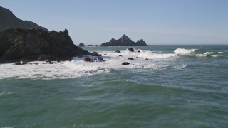 AXSF15_042 - 5K aerial stock footage of flying over the ocean, tilt up to reveal rock formations, Pacifica, California