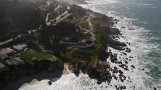 AXSF15_047 - 5K aerial stock footage of tilting from Montara State Beach, revealing coastal neighborhoods and lighthouse, Montara, California