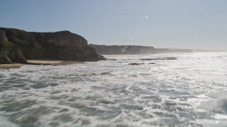 AXSF15_059 - 5K aerial stock footage fly low altitude by coastal cliffs and over rock formations, Half Moon Bay, California