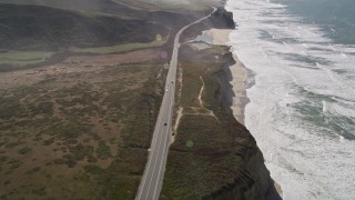 AXSF15_067 - 5K aerial stock footage tilt from bird's eye of Highway 1 beside San Gregorio State Beach, San Gregorio, California