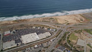 5K aerial stock footage fly away from Fort Ord Dunes State Park, reveal Highway 1 coastal road, Moss Landing, California Aerial Stock Footage | AXSF15_117