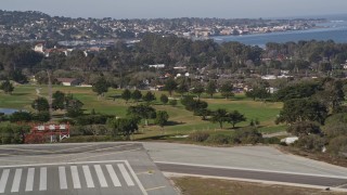 AXSF15_122 - 5K aerial stock footage tilt from golf course to reveal the coastal community of Monterey, California