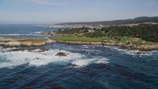 AXSF16_024 - 5K aerial stock footage ocean waves rolling toward Cypress Point Golf Course, Pebble Beach, California