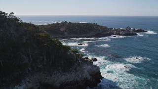 AXSF16_046 - 5K aerial stock footage of rounding rugged coastal cliffs in Carmel, California