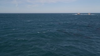 AXSF16_056 - 5K aerial stock footage of tilting from ocean waves  to reveal coastal rock formations, Carmel, California