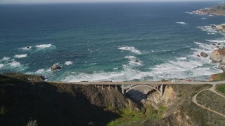 AXSF16_068 - 5K aerial stock footage of flying away from Rocky Creek Bridge above coastal cliffs, Carmel, California