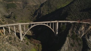 5K aerial stock footage of light traffic on the Bixby Creek Bridge above coastal cliffs, Big Sur, California Aerial Stock Footage | AXSF16_072