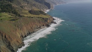 AXSF16_108 - 5K aerial stock footage of tilting from ocean kelp to reveal coastal cliffs, Big Sur, California