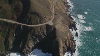 5K aerial stock footage of flying by small beach, pan right to Highway 1 atop coastal cliffs, Big Sur, California Aerial Stock Footage | AXSF16_129