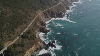 5K aerial stock footage of flying by a small bridge and Highway 1 atop coastal cliffs, Big Sur, California Aerial Stock Footage | AXSF16_130