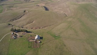 5K aerial stock footage reverse view of open lands, revealing a ranch house, Central California Aerial Stock Footage | AXSF16_146