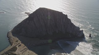 5K aerial stock footage of flying by Morro Rock overlooking the ocean in Morro Bay, California Aerial Stock Footage | AXSF16_153