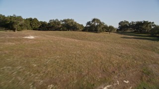 5K aerial stock footage of flying low over hills and trees in San Luis Obispo County, California Aerial Stock Footage | AXSF17_005