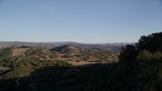 5K aerial stock footage tilt up from trees and fly over hills in San Luis Obispo County, California Aerial Stock Footage | AXSF17_010