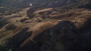 5K aerial stock footage of a reverse view of small buildings on the hills, San Luis Obispo County, California Aerial Stock Footage | AXSF17_015