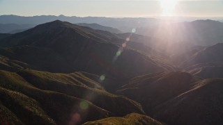 5K aerial stock footage flyby mountains with sun in the distance, San Luis Obispo County, California Aerial Stock Footage | AXSF17_019