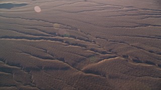 5K aerial stock footage of flying by deep cracks in the desert, Cuyama Valley, California Aerial Stock Footage | AXSF17_028