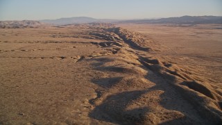 AXSF17_042 - 5K aerial stock footage fly over San Andreas Fault, tilt for a view of desert valley, distant mountains, San Luis Obispo County, California