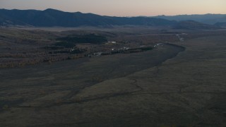 CAP_002_020 - HD stock footage aerial video of autumn trees, hills and a river in Jackson Hole, Wyoming, twilight