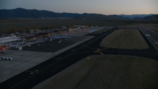 CAP_002_025 - HD stock footage aerial video pan to terminals and hangers at Jackson Hole Airport, Wyoming, twilight