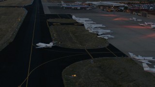 CAP_002_026 - HD stock footage aerial video of a jet taxiing onto the runway at Jackson Hole Airport, Wyoming, twilight