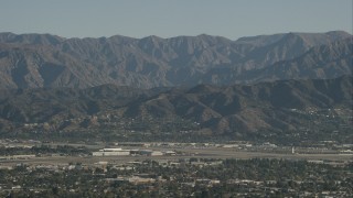 HD stock footage aerial video of Bob Hope International Airport and mountain ridges in Burbank, California Aerial Stock Footage | CAP_004_004