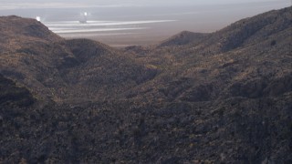 HD stock footage aerial video tilt from mountains to reveal Ivanpah Solar Electric Generating System, Mojave Desert, California Aerial Stock Footage | CAP_005_020