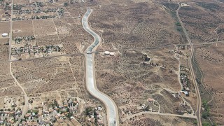 HD stock footage aerial video flyby rural desert homes around the California Aqueduct in Palmdale, California Aerial Stock Footage | CAP_006_006