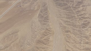 HD stock footage aerial video bird's eye view of open desert and reveal a highway in San Bernardino County, California Aerial Stock Footage | CAP_006_011