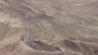 HD stock footage aerial video of a reverse view of radio towers and Mojave Desert mountains in San Bernardino County, California Aerial Stock Footage | CAP_006_018