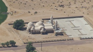 HD stock footage aerial video of reverse view of a Mojave Desert monastery in Newberry Springs, California Aerial Stock Footage | CAP_006_025