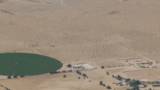 HD stock footage aerial video zoom to a wiper view of a Mojave Desert monastery and crop circle in Newberry Springs, California Aerial Stock Footage | CAP_006_026