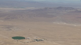 HD stock footage aerial video zoom to a wiper view of a lonely Mojave Desert monastery and crop circle in Newberry Springs, California Aerial Stock Footage | CAP_006_027