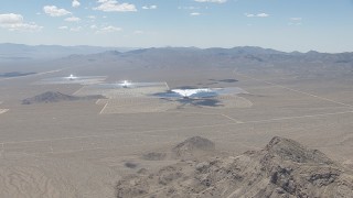 HD stock footage aerial video of a view across the open desert at the Ivanpah Solar Electric Generating System in California Aerial Stock Footage | CAP_006_041