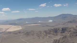 HD stock footage aerial video of a view of the three solar arrays at Ivanpah Solar Electric Generating System in California next to a highway Aerial Stock Footage | CAP_006_047