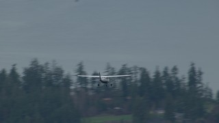 CAP_009_009 - HD stock footage aerial video track an airplane flying over Puget Sound and evergreen trees, Washington