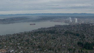 HD stock footage aerial video fly over homes to approach cargo ship in Commencement Bay, Tacoma, Washington Aerial Stock Footage | CAP_009_017