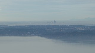 HD stock footage aerial video of the hazy Downtown Seattle skyline seen from Puget Sound, Washington Aerial Stock Footage | CAP_009_024