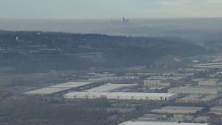 HD stock footage aerial video of the Downtown Seattle city skyline seen from warehouse buildings in Kent, Washington Aerial Stock Footage | CAP_009_033