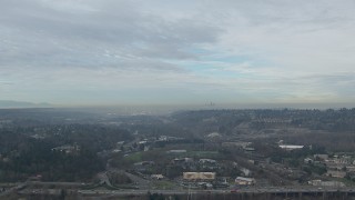 HD stock footage aerial video of Downtown Seattle skyline seen while approaching hotel and office buildings by I-405 in Tukwila, Washington Aerial Stock Footage | CAP_009_037