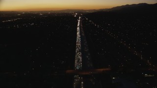 HD stock footage aerial video tilt from heavy traffic on the I-10 freeway at twilight through the in the San Gabriel Valley, California Aerial Stock Footage | CAP_010_003