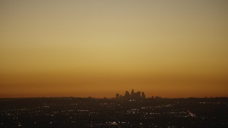 HD stock footage aerial video bright light over the Downtown Los Angeles city skyline at twilight, California Aerial Stock Footage | CAP_010_007