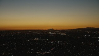 HD stock footage aerial video approach the hazy Downtown Los Angeles city skyline at twilight, California Aerial Stock Footage | CAP_010_009