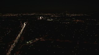 HD stock footage aerial video tilt from freeway gridlock to the Downtown Los Angeles city skyline at night, California Aerial Stock Footage | CAP_010_011