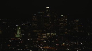 HD stock footage aerial video of a view of the Downtown Los Angeles city skyline and city hall at night, California Aerial Stock Footage | CAP_010_012