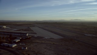 HD stock footage aerial video approach and pan across the Barstow-Daggett Airport in California at sunrise Aerial Stock Footage | CAP_011_006