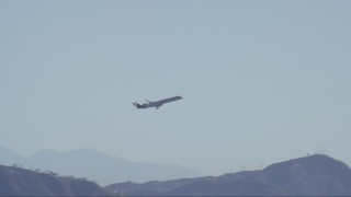 CAP_012_002 - HD stock footage aerial video of commercial jet ascending toward blue skies over Burbank, California