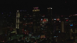 HD stock footage aerial video of Mercedes Benz Stadium while flying by skyscrapers at night, Downtown Atlanta, Georgia Aerial Stock Footage | CAP_013_005